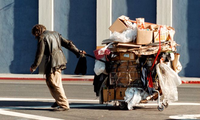 Homeless man with shopping cart