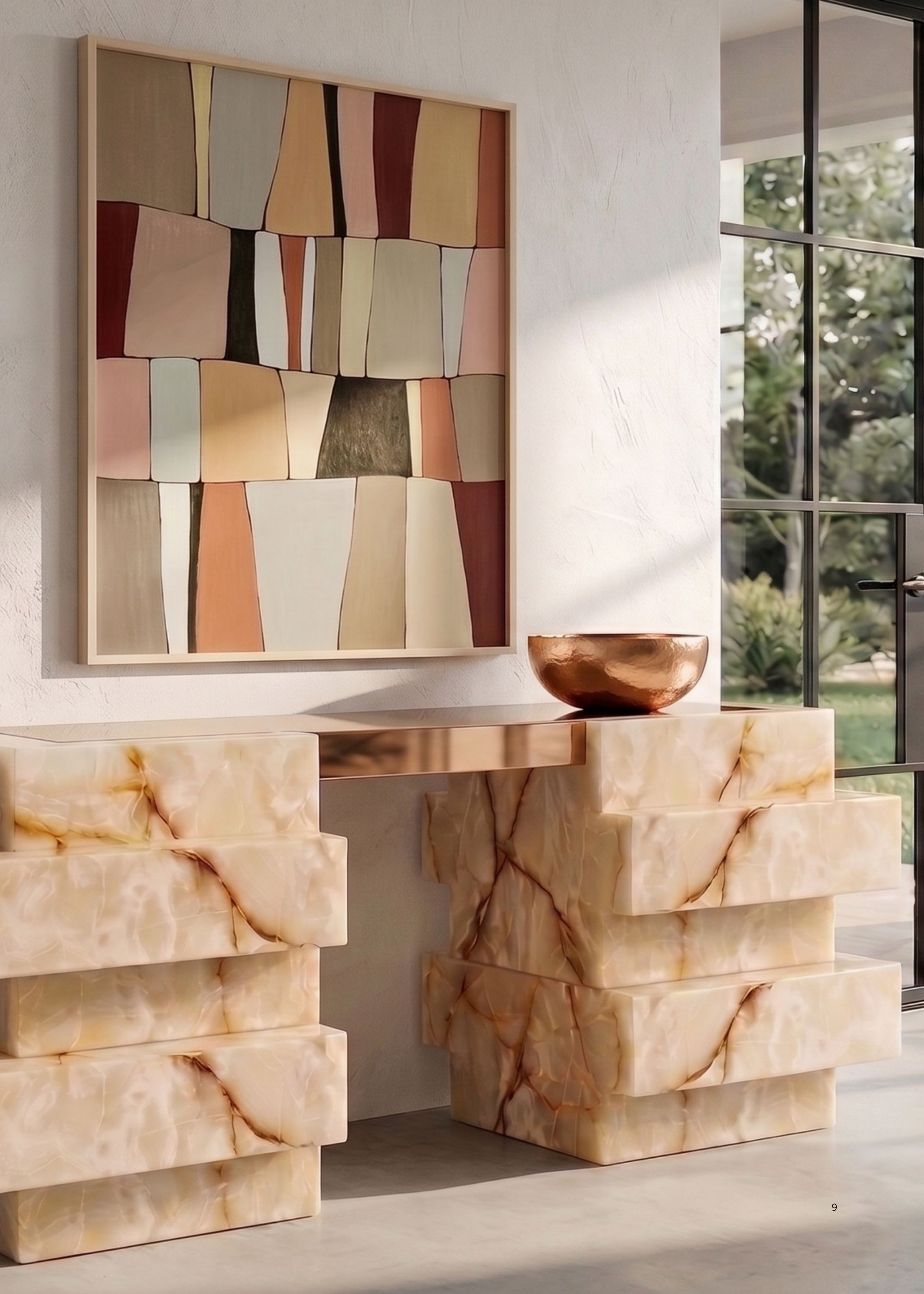 Image of a structural, yellow marble console table with a copper bowl on it and an abstract painting above it. 