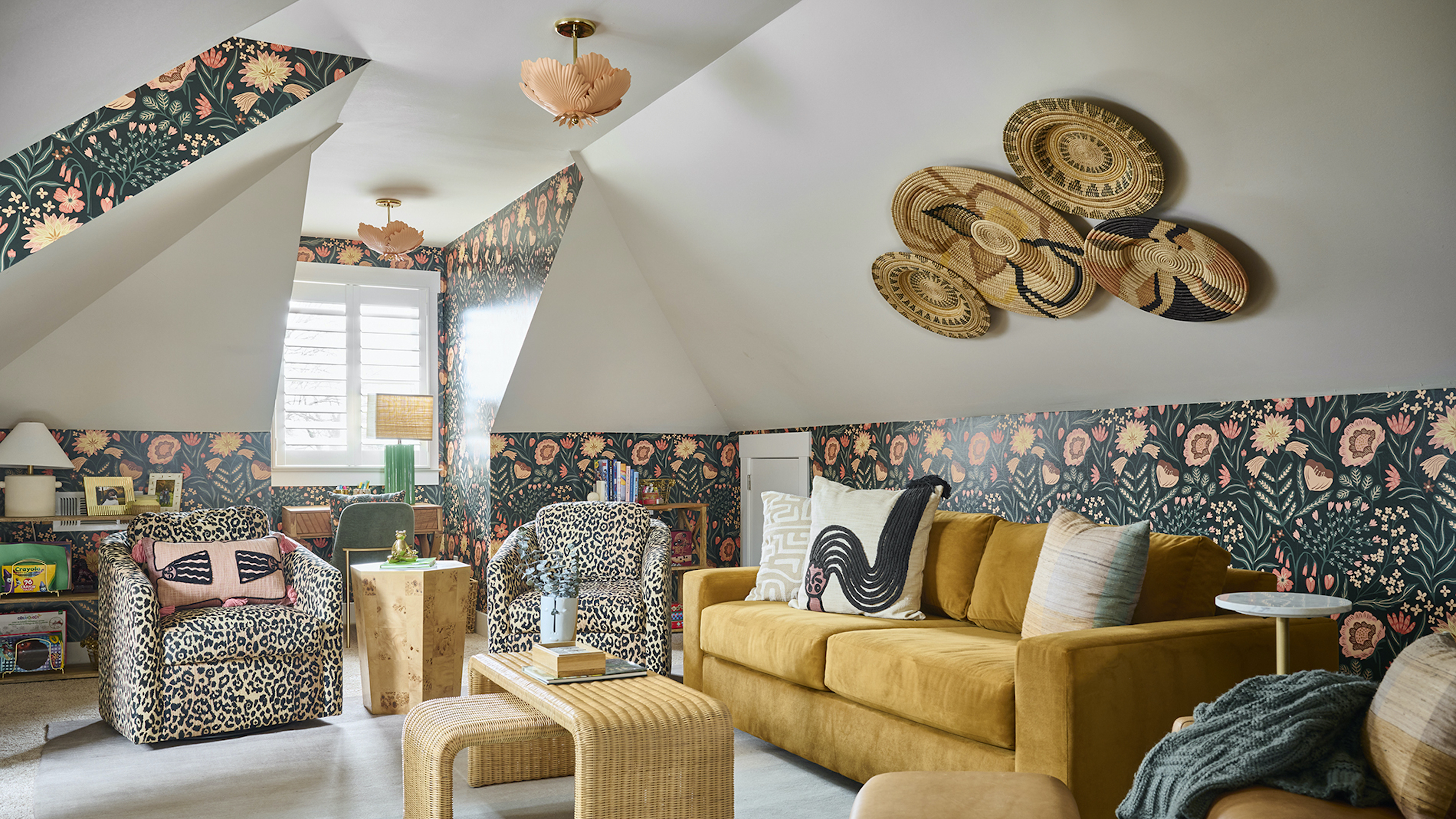 loft conversion with mustard sofa and green and peach wallpaper