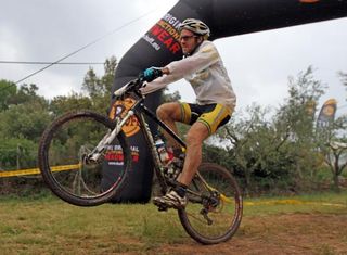 Jason English (Australia)celebrates his win with a wheelie