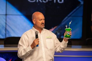 Ken Shields, chief operating officer of the International Space Station National Laboratory, holds a pouch of the Nickelodeon slime during a prelaunch news conference at NASA's Kennedy Space Center in Florida on July 23, 2019.
