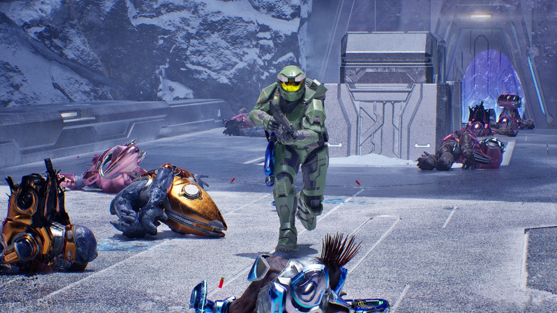 Master Chief running across a snowy bridge covered in alien bodies, with his assault rifle raised, in Halo: Campaign Evolved