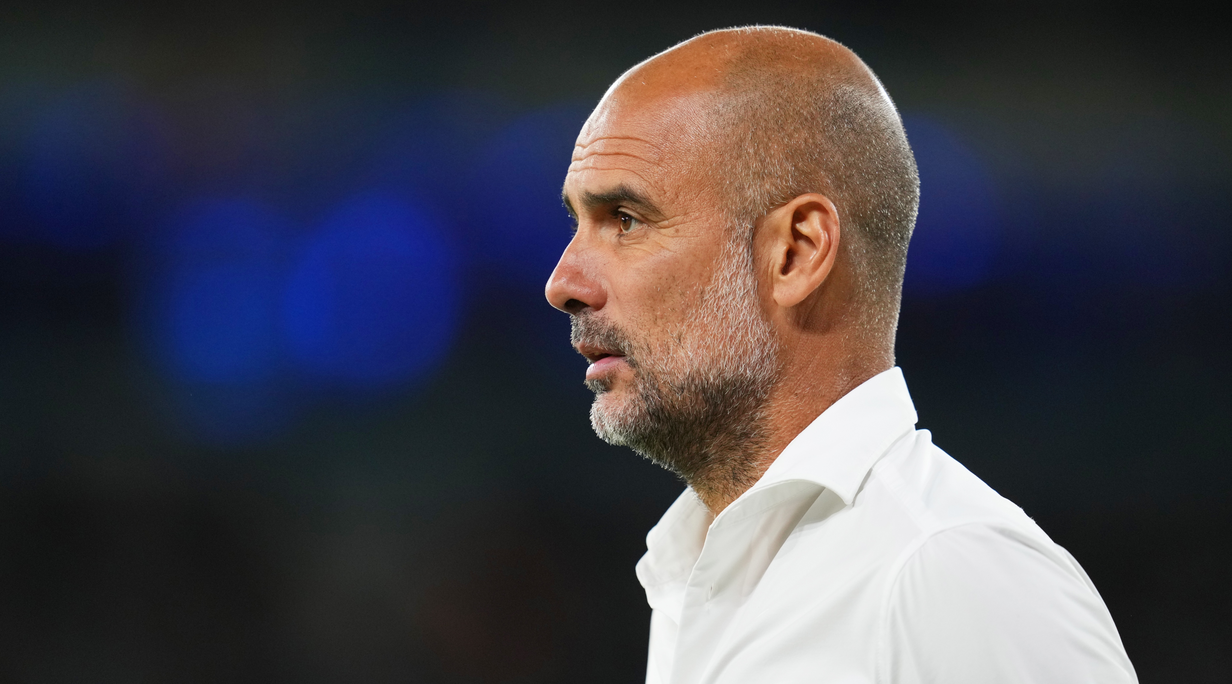 Close-up, side-on shot of Manchester City manager Pep Guardiola