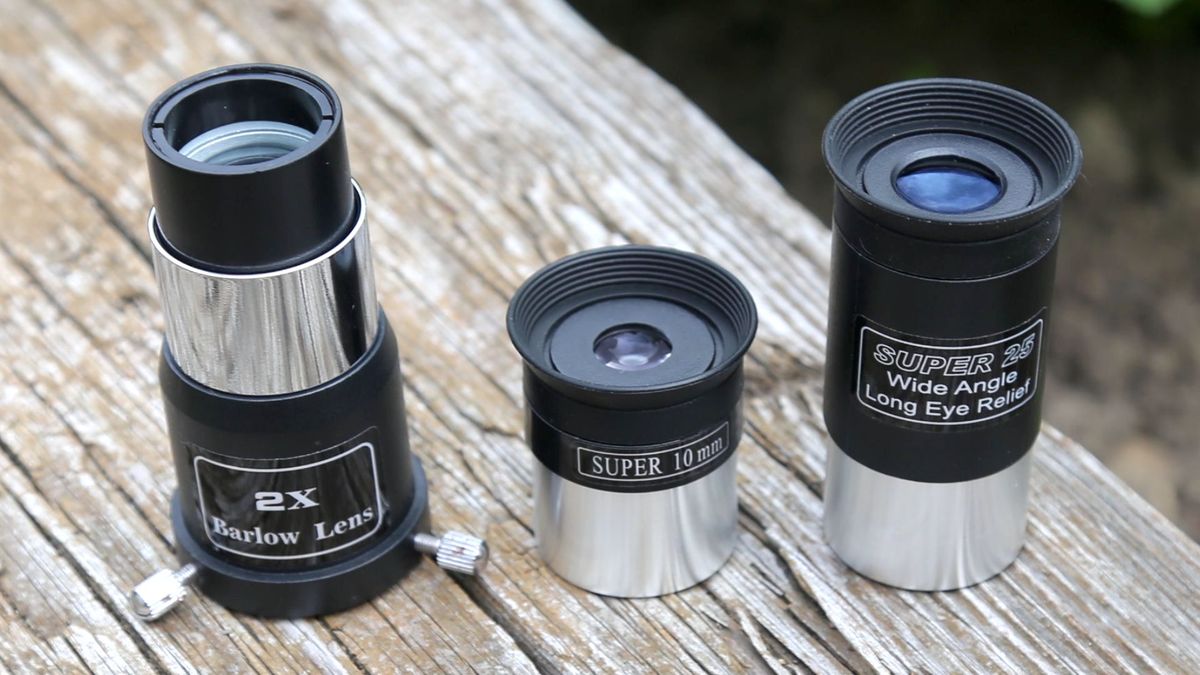 three telescope eyepieces on a wooden table