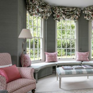 Mid grey living room with patterned pink upholstery on armchair and cushions