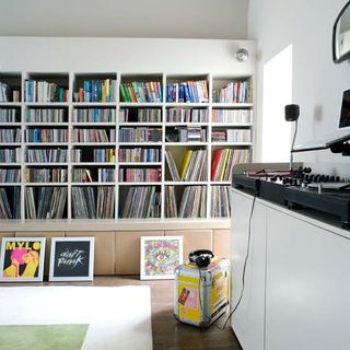 room with book shelves and wooden floor and white wall