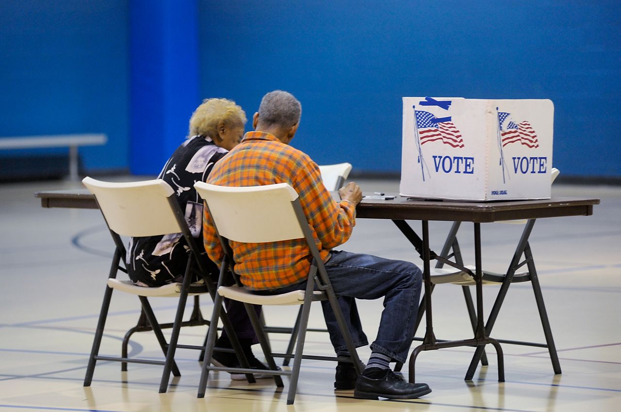 An elderly couple voting.