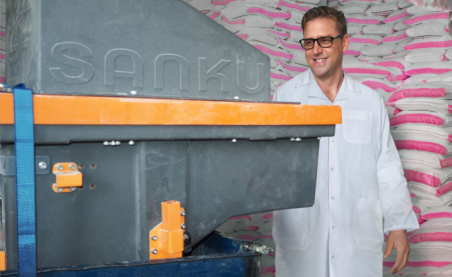 Man standing in front of a big box at a factory