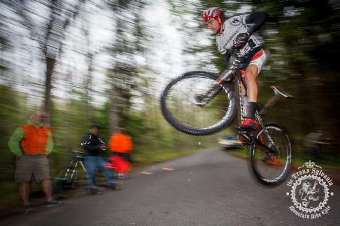 Payson McElveen jumps the road gap at the bottom of the last enduro section