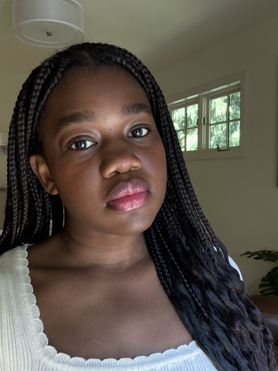 Associate beauty editor Maya Thomas with glossy braids after using Olaplex No. 7 Bonding Oil.