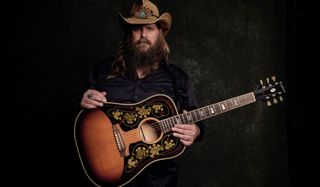 Chris Stapleton holds his new signature Epiphone Frontier acoustic guitar