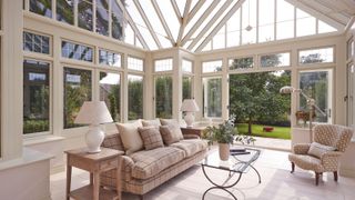 a conservatory with a sofa and table lamp