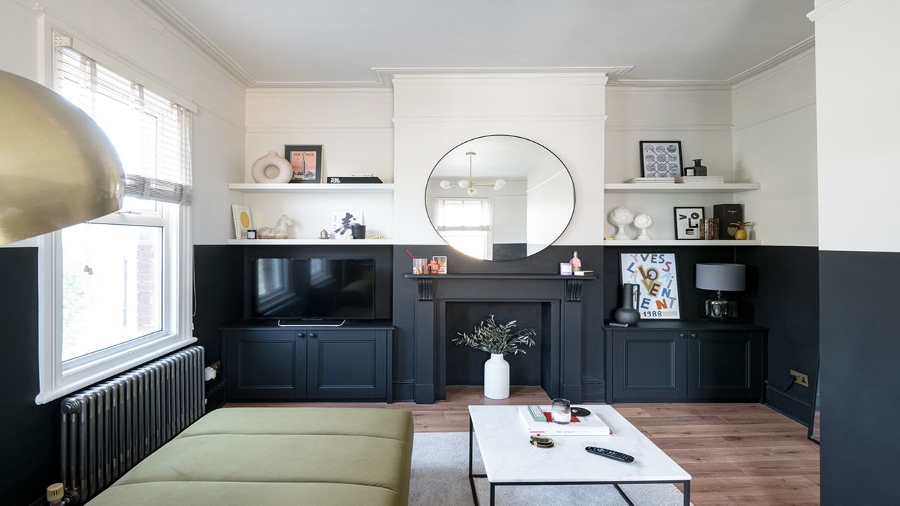 living room with fireplace and round mirror