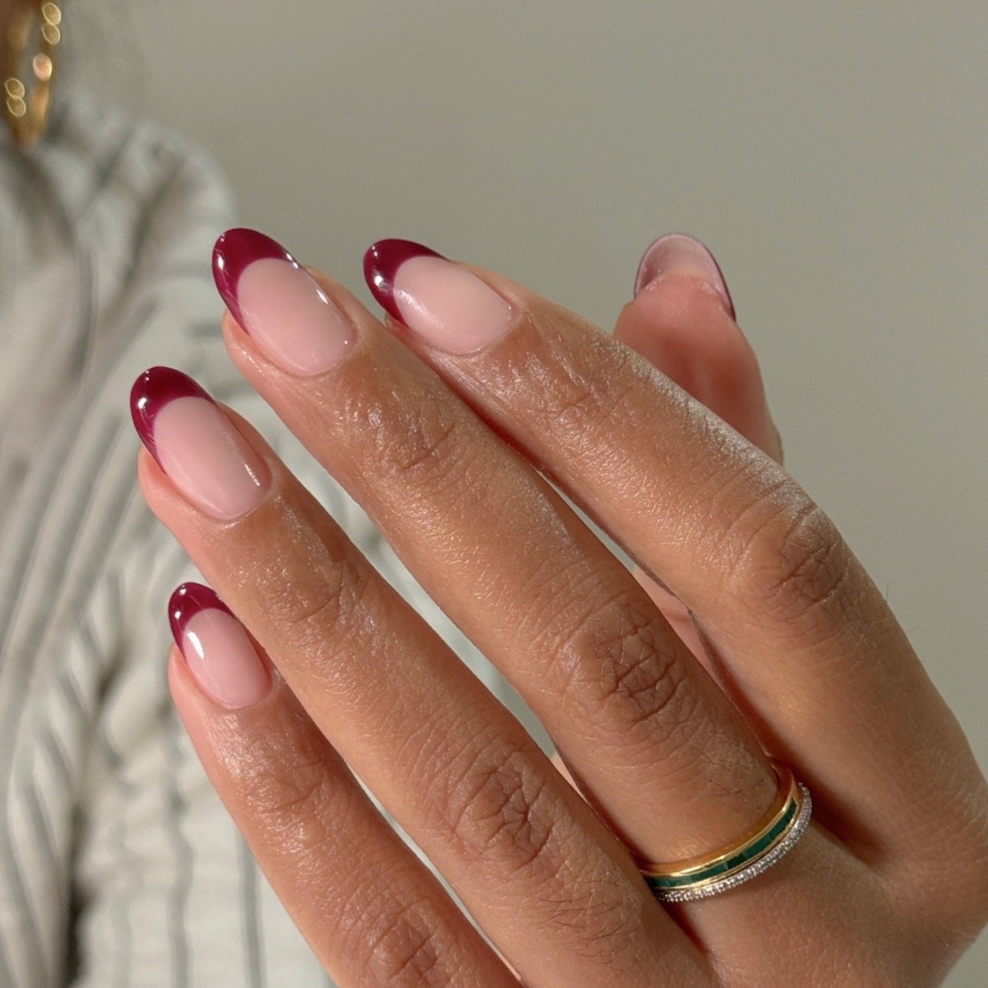 A close-up picture of purple curved French tips