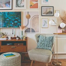 A living room gallery wall featuring the Samsung Frame TV displaying a Monet painting