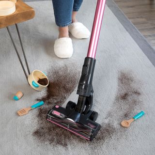 Coffee being vacuumed up from rug
