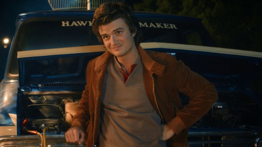 Steve leaning against a van in Stranger Things. 