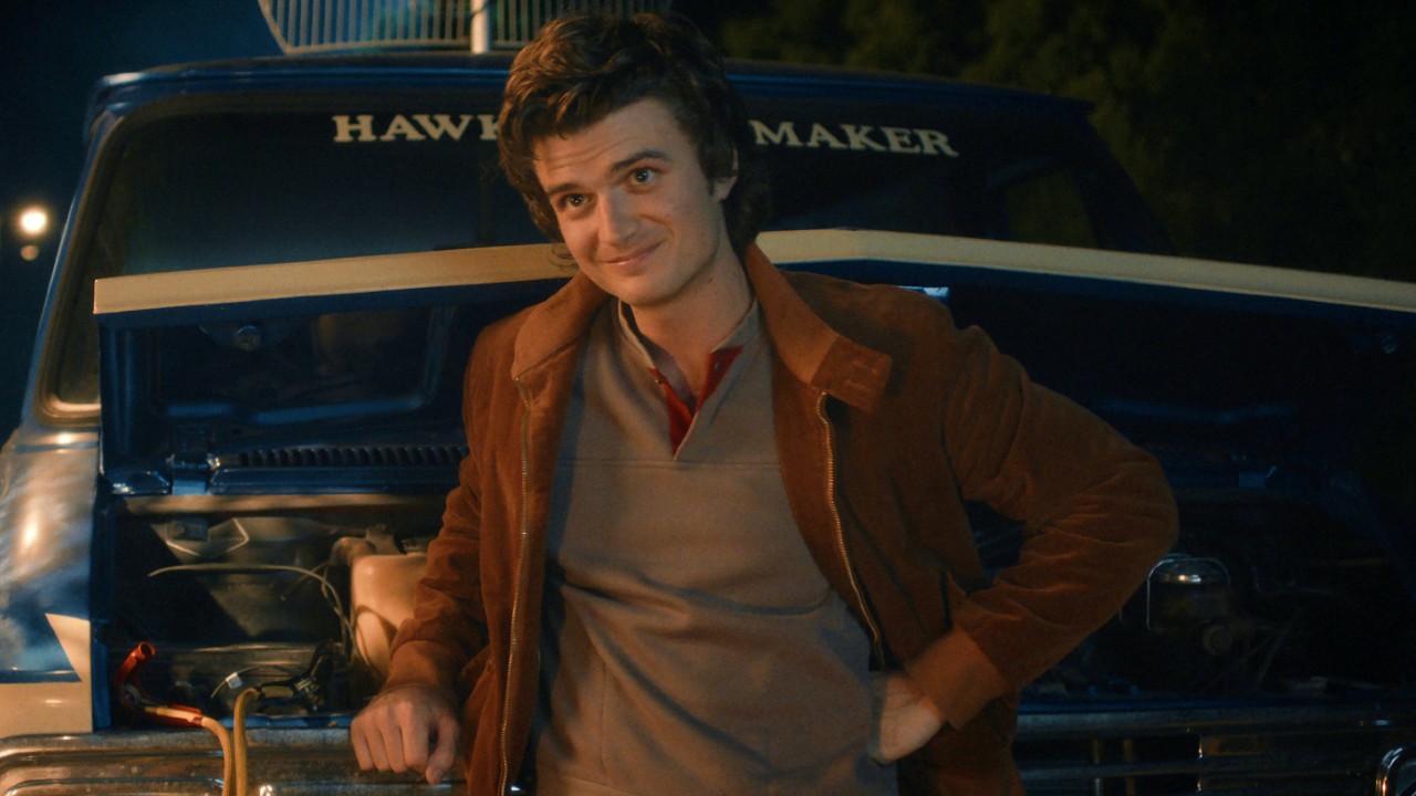 Steve leaning against a van in Stranger Things. 