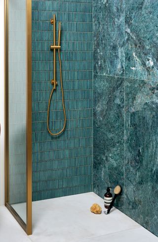 a shower enclosure with three different types of tile