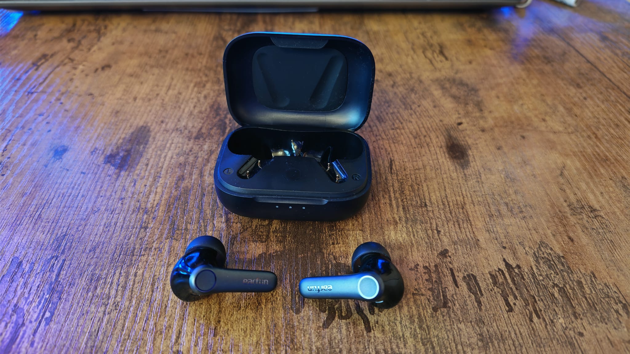 The EarFun Air Pro 4 earbuds out of their case