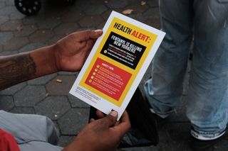 A few years ago, a person in New York City reads a flyer on the dangers of Fentanyl.