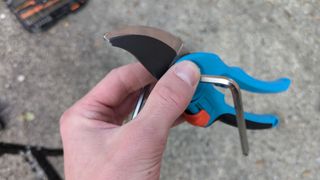 Disassembling a bypass pruner using two hex keys