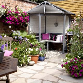 garden with sheltered seating area and potted plants