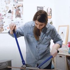 woman making copper coat hangers