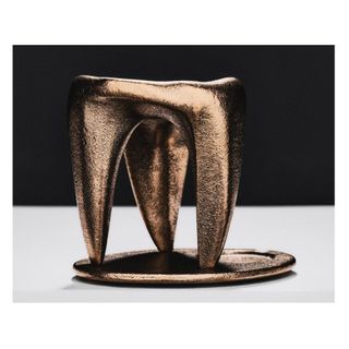 oil burner in the shape of brass tooth