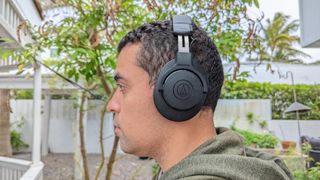 Our reviewer wearing the Audio-Technica ATH-M20xBT in a backyard setting