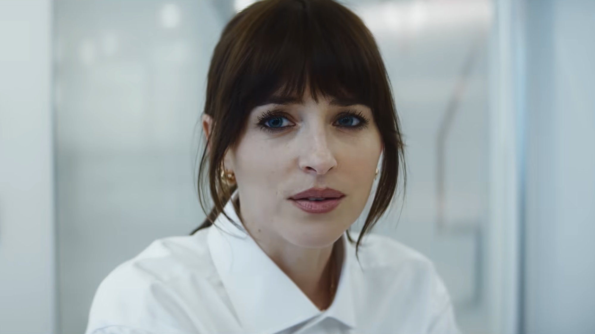 Dakota Johnson wearing white and bangs in the Verity trailer.