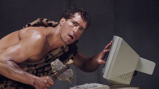 caveman using a computer