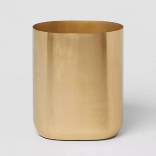 A gold small trash can