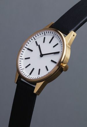 Watch with gold frame, white face and black strap