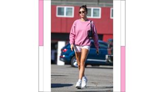 Hailey Bieber seen wearing sunglasses, a pink sweatshirt and light pink bicycle shorts