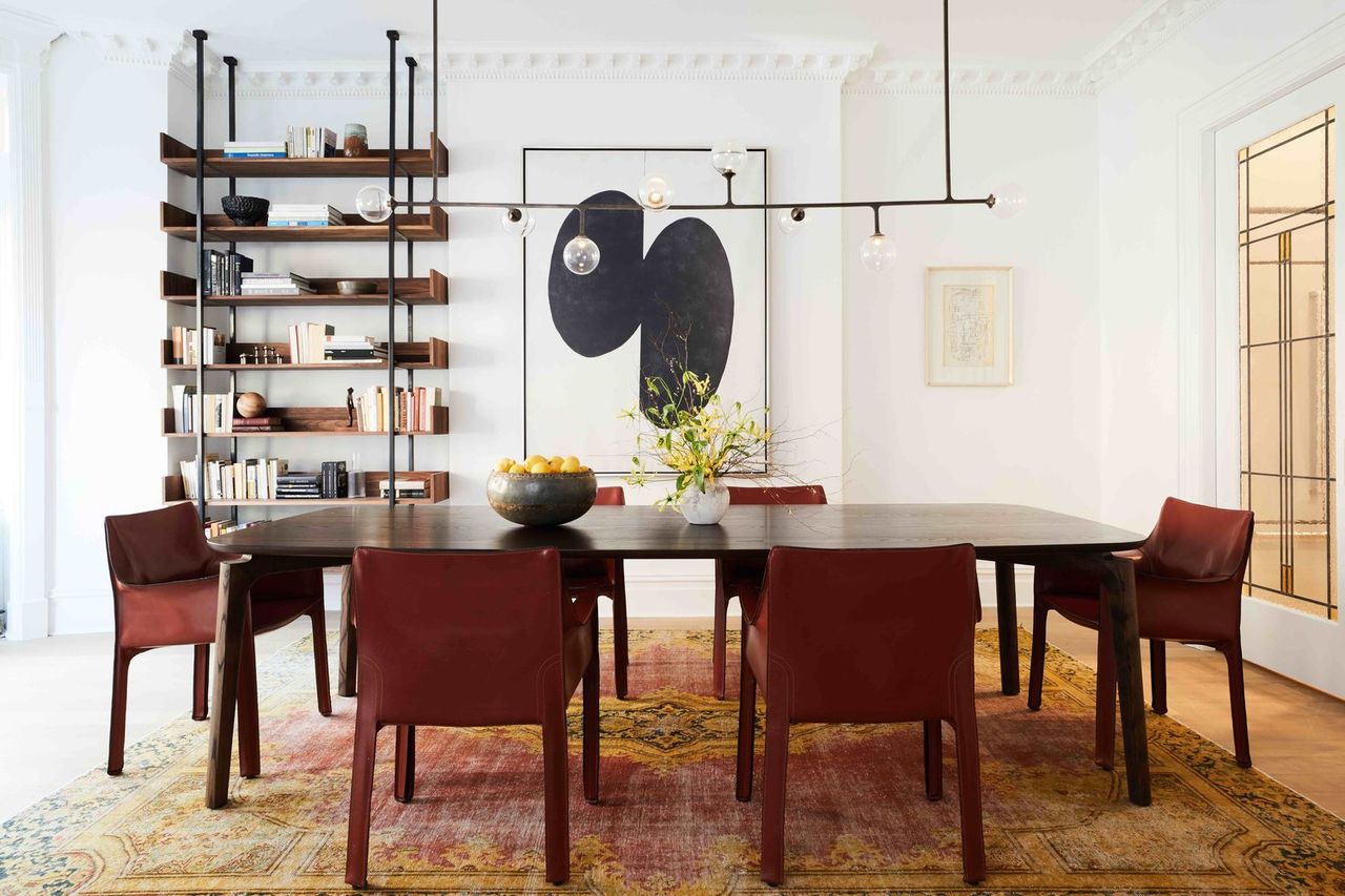 A dining room with modern dining chairs and a decorated dining table