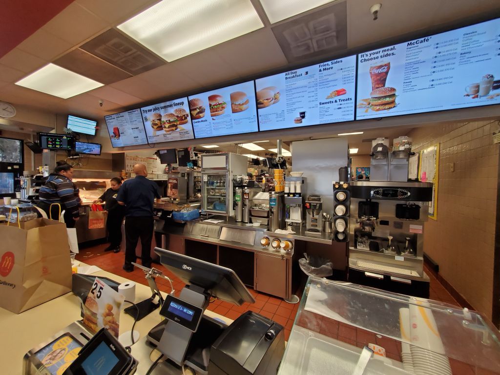 Counter area, kitchen and menus are visible in wide angle view in interior of McDonald&#039;s restaurant in San Ramon, California