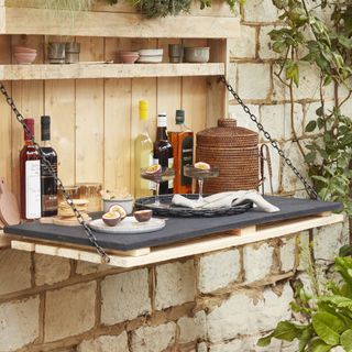 fold down wooden bar built onto garden wall