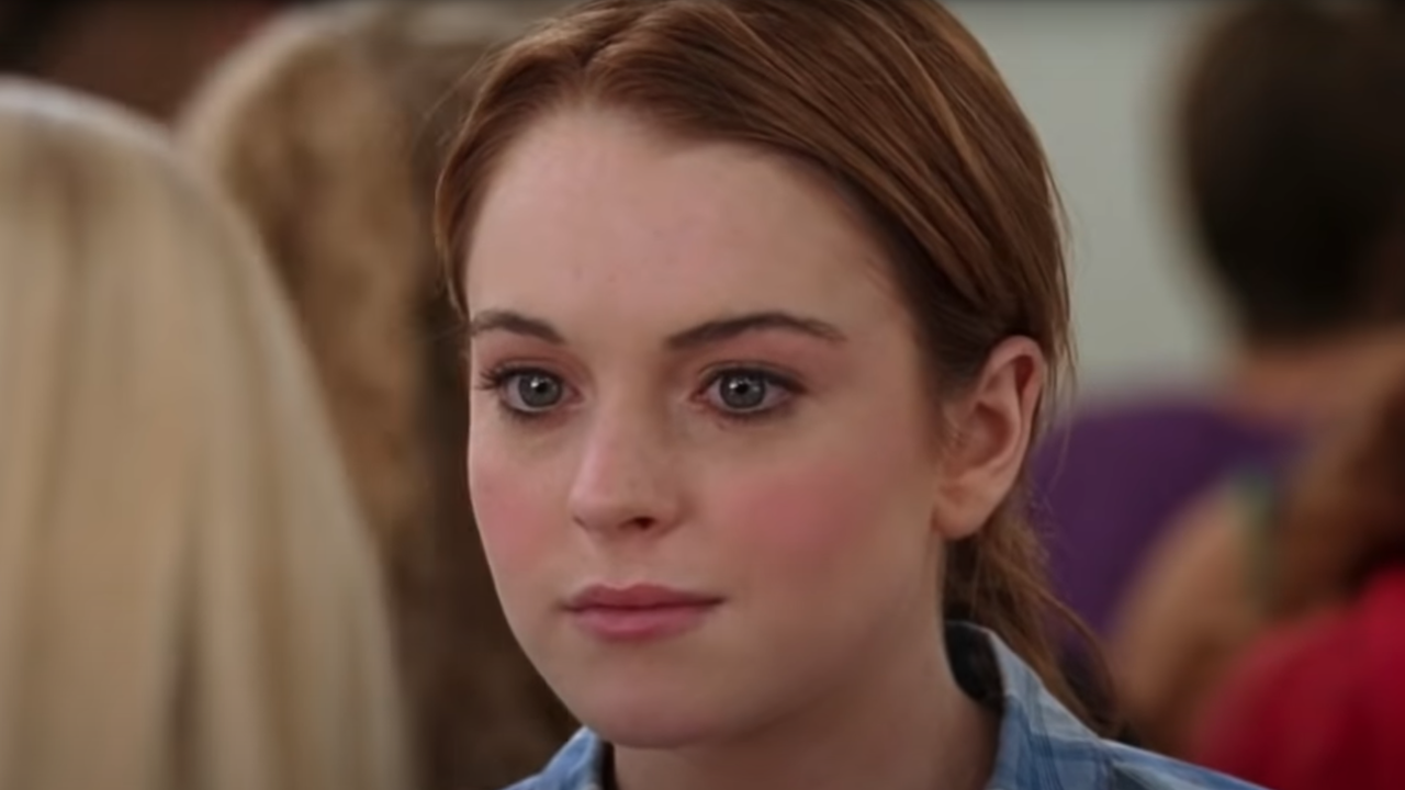 Cady Heron (Lindsay Lohan) sits in the dining room looking uncomfortable in a scene from Mean Girls
