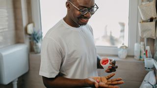 man taking a supplement