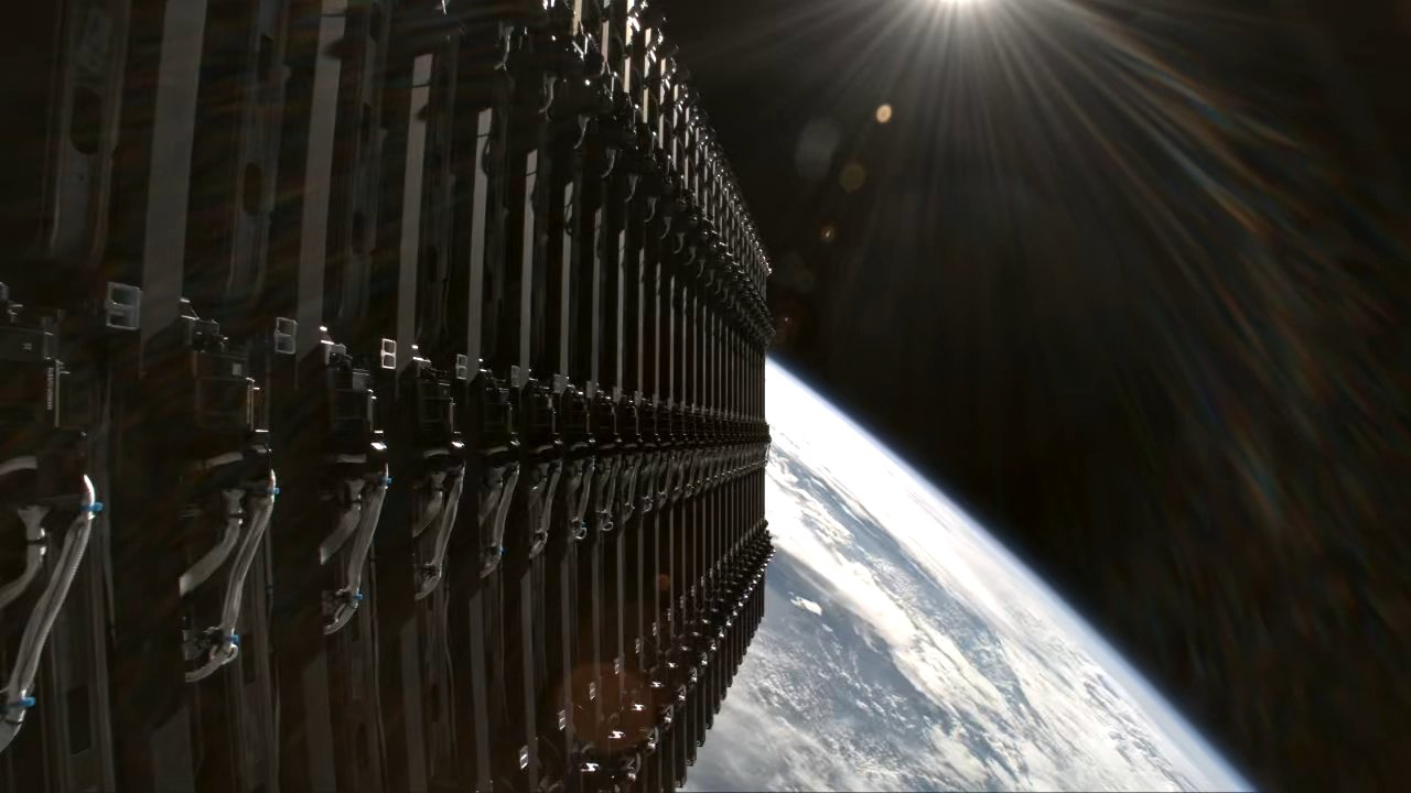 view from the upper stage of a rocket in orbit, showing a stack of undeployed satellites with earth in the background