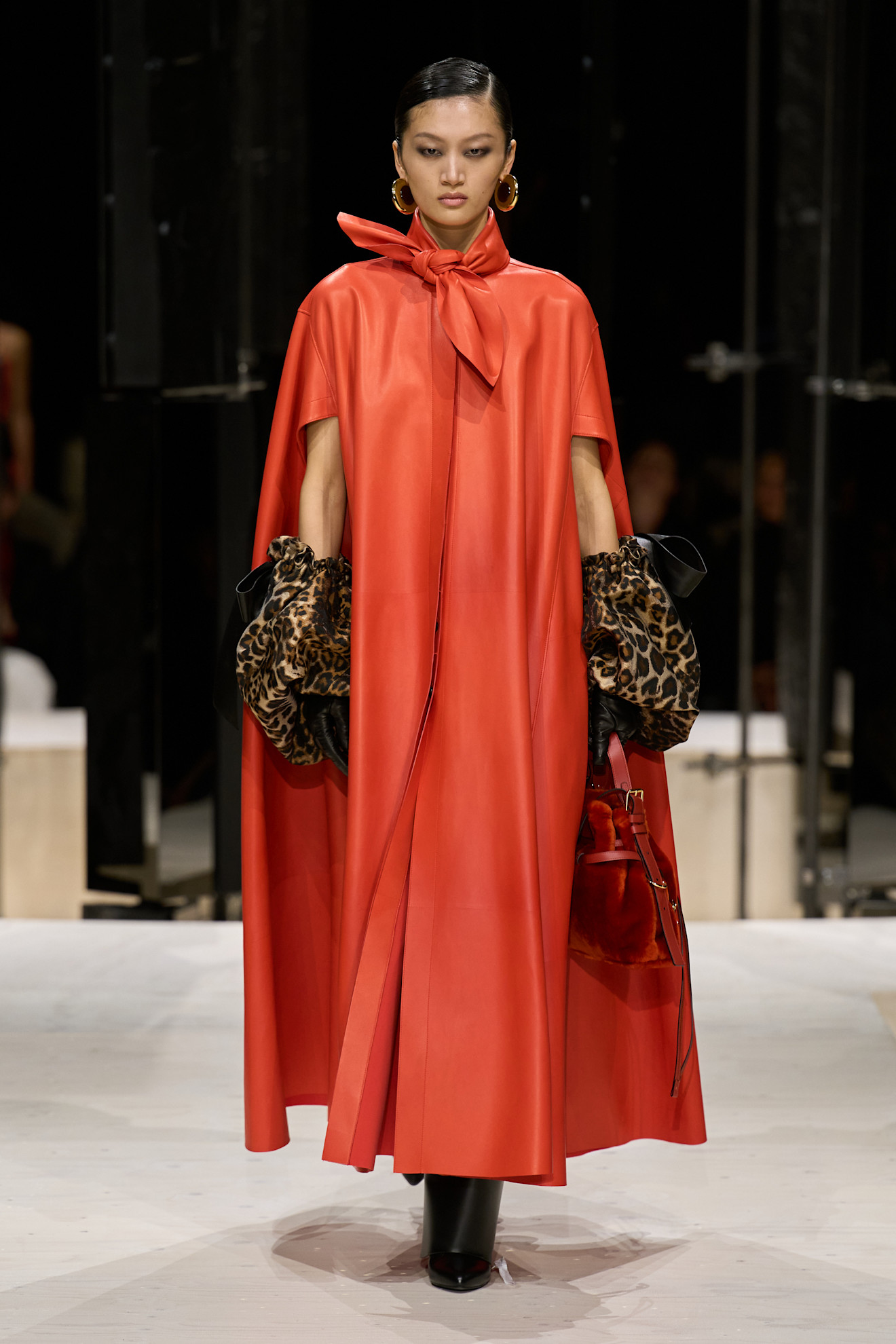 a model wears leopard gloves and a dress