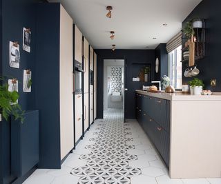 navy and cream kitchen with storage along both walls