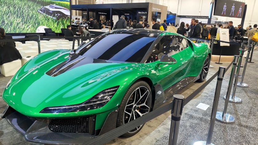 A green Dreame hypercar in a show booth