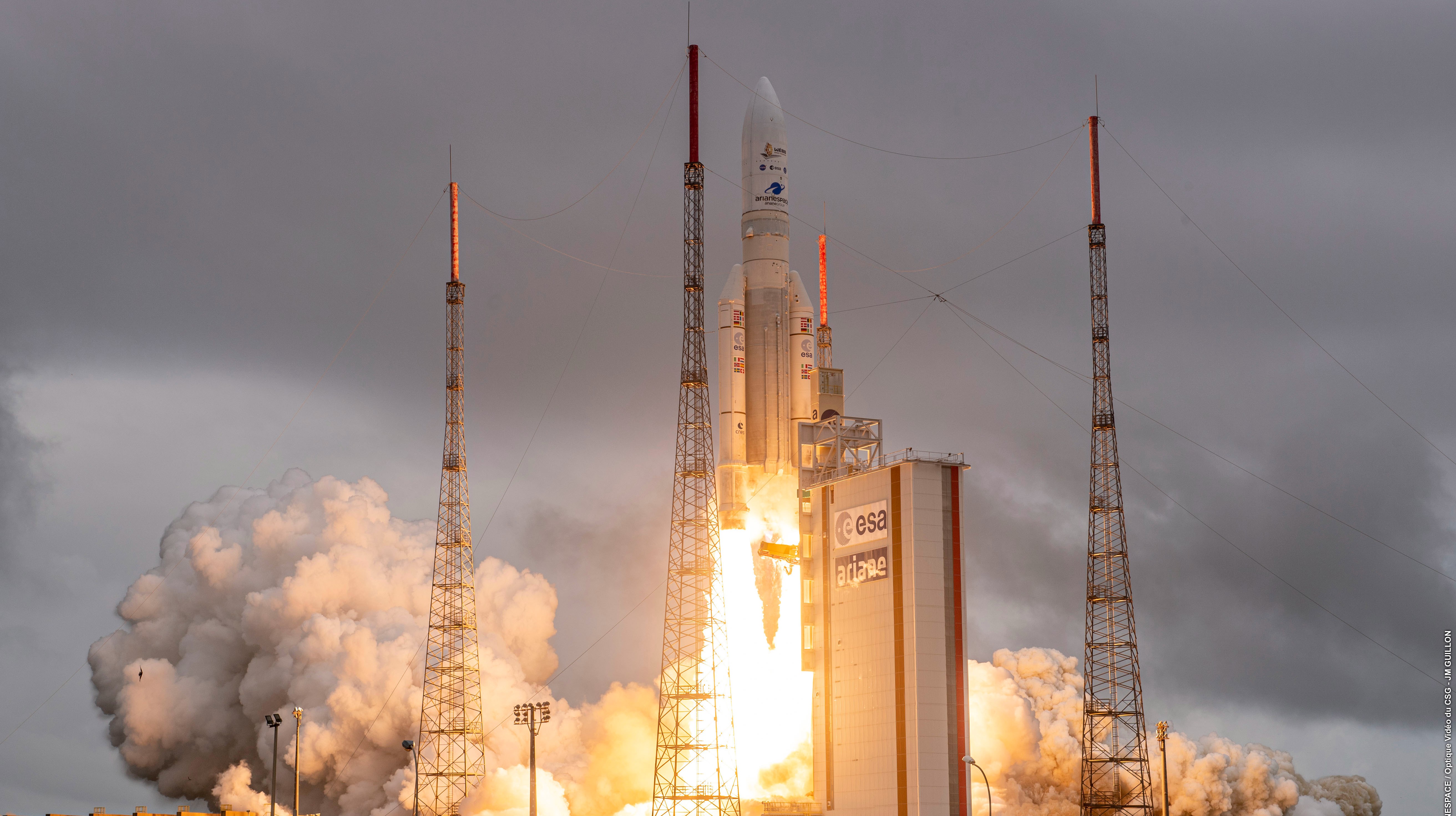 a white arianespace rocket lifts off from kourou, french guiana on dec. 25, 2021, carrying the james webb space telescope off earth