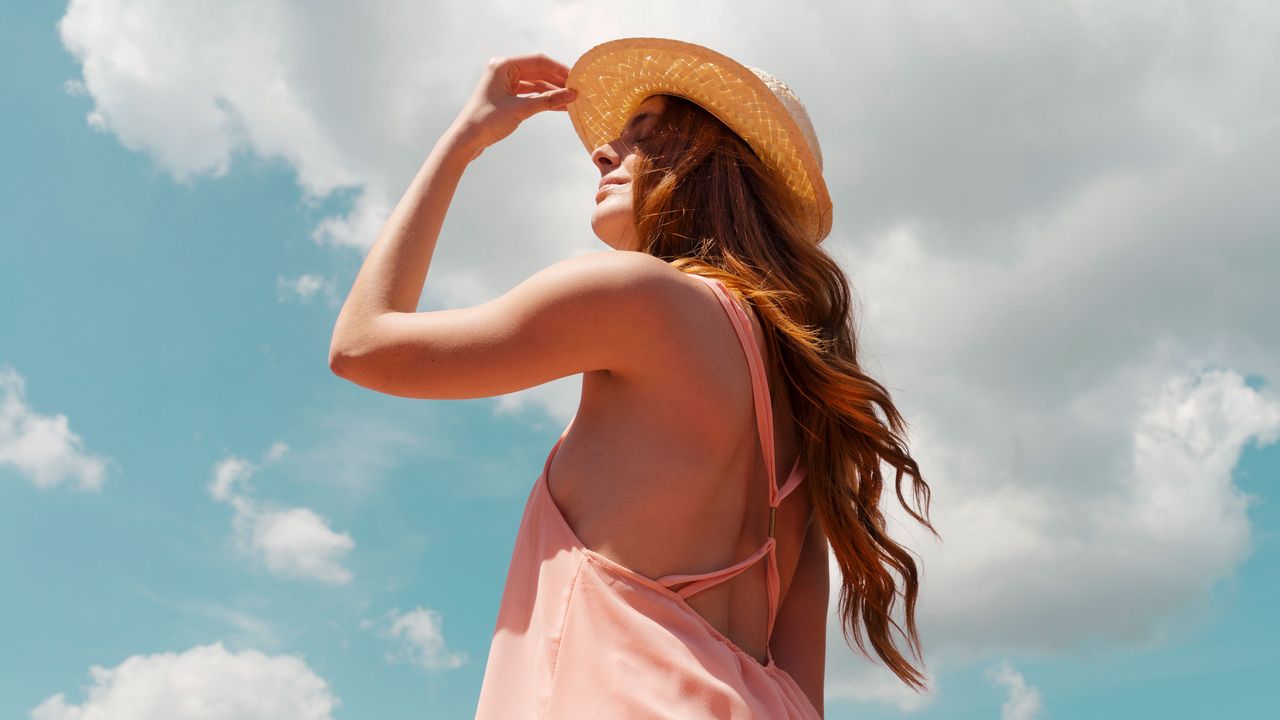 redheaded woman enjoying sunlight during summer solstice