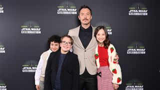 Jude Law and some members of Skeleton Crew's young cast post for a photograph at Star Wars Celebration 2023.