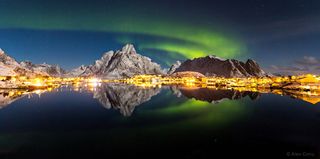 In a moonlit night of Lofoten Islands Norway, the aurora borealis appears over the Reine fishing village. Alex Conu took second place in the "Against the Lights" category in the 2014 International Earth & Sky Photo Contest.