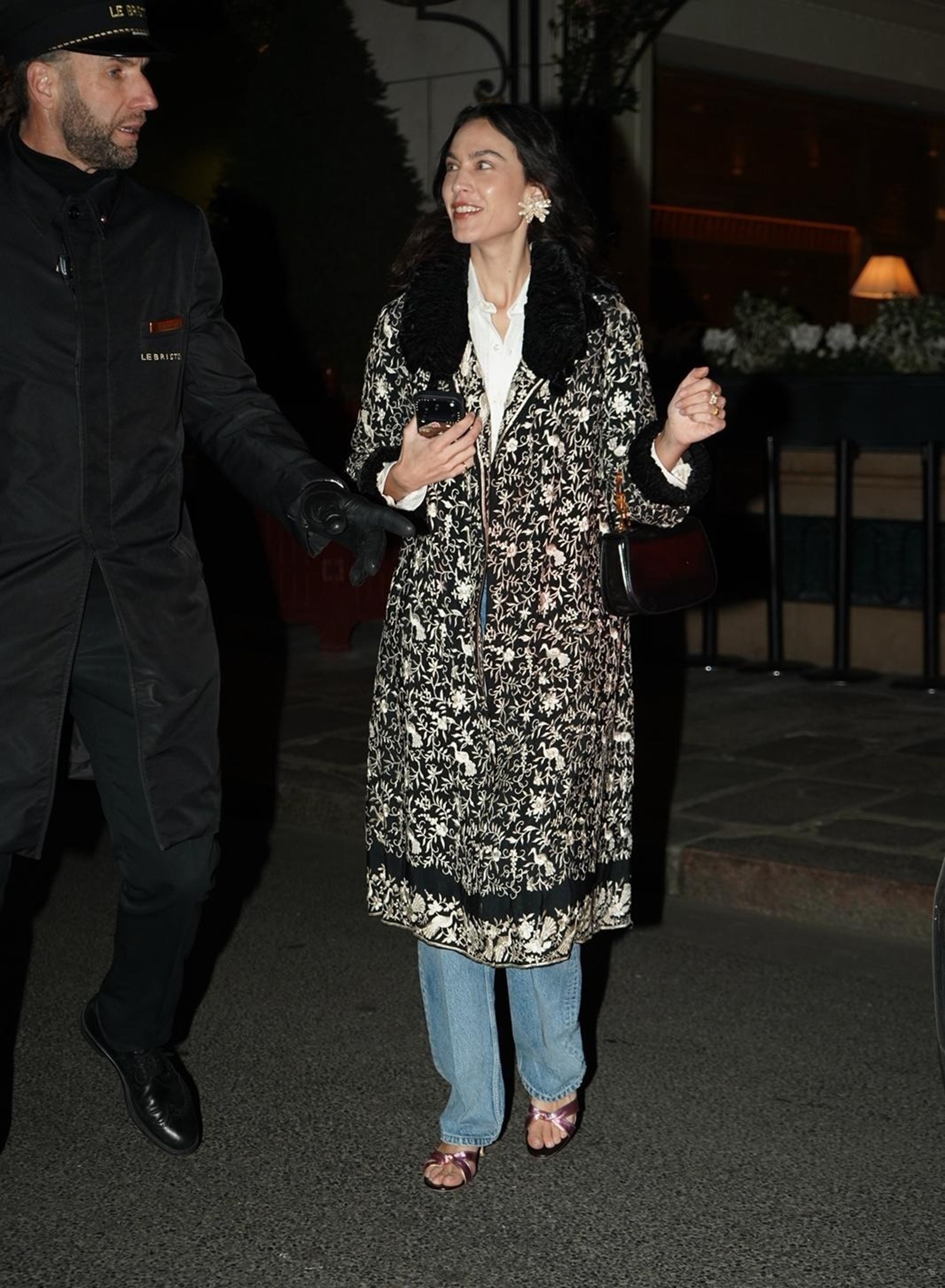 Alexa Chung wears an ornate jacket with straight-leg jeans, lilac heels and oversized earrings.
