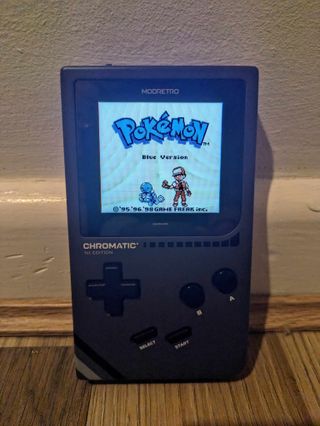 Modretro Chromatic review; a Game Boy like retro console on a wooden floor